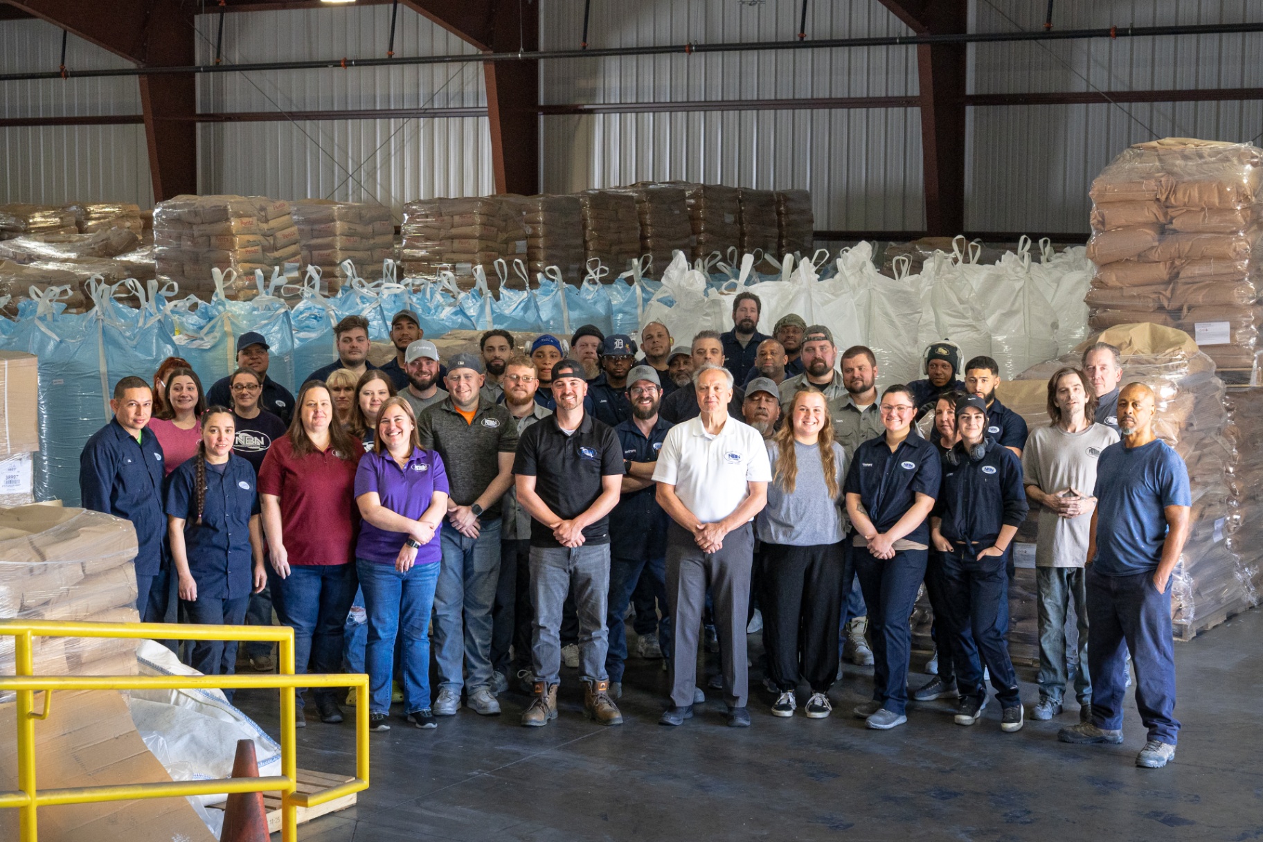 U.S. Chemical Services production team group photo on the warehouse floor