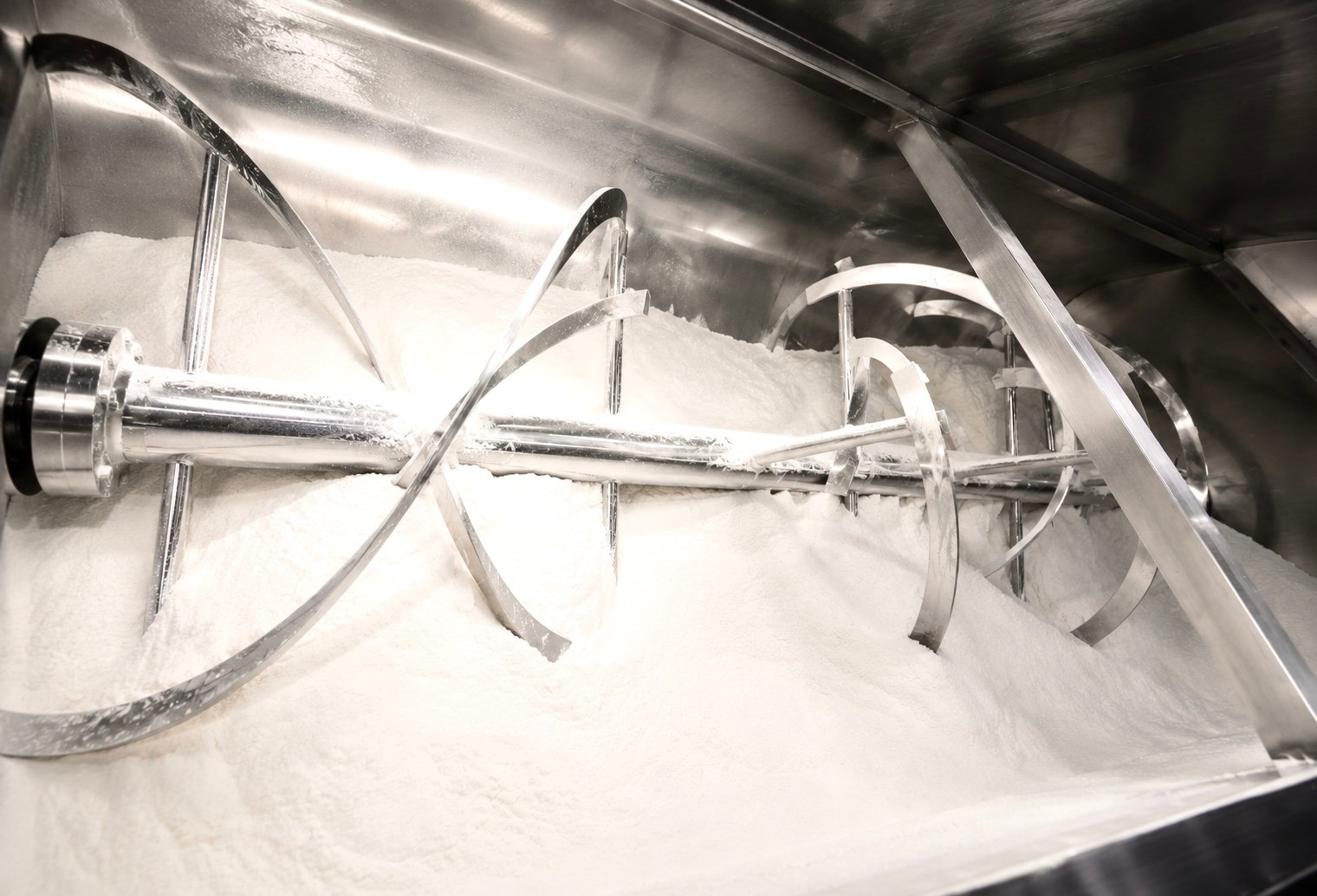 Inside a charged ribbon blender mixing dry chemical powders