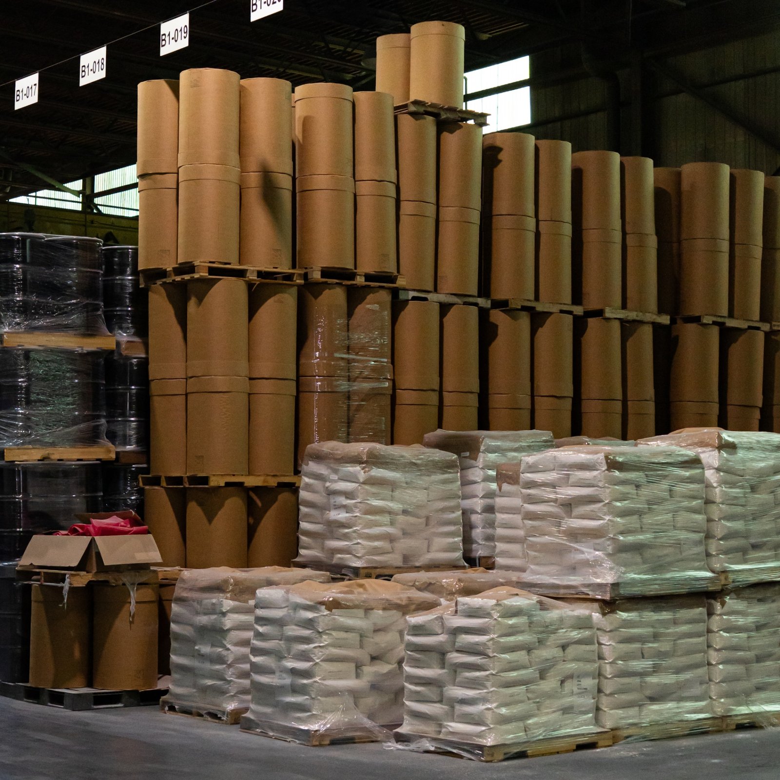 Bag sewing closing filled chemical bags on the packaging line